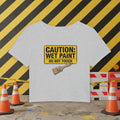 Gray cropped t-shirt with a yellow 'Caution: Wet Paint' sign and paintbrush on a white background